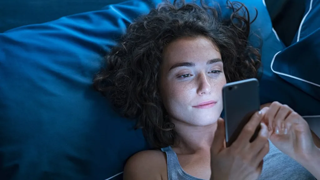 lady on her phone in bed